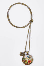 A model wearing the Vintage Bird Pendant w Birdhouse Charm in colour PinkMulti (Pink), from the front, showing the whole outfit