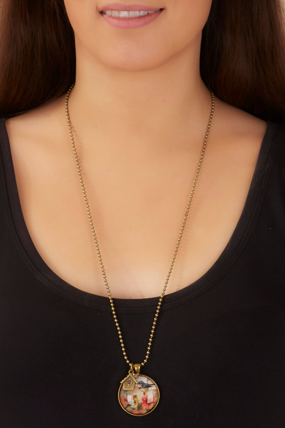 A model wearing the Vintage Bird Pendant w Birdhouse Charm in colour PinkMulti (Pink), from the front, showing the whole outfit