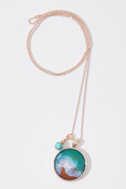 A model wearing size OneSize of the Sapphire Coast Pendant With Turquoise Magnesite Necklace in colour Metallic (Metallics), from the front, showing the whole outfit