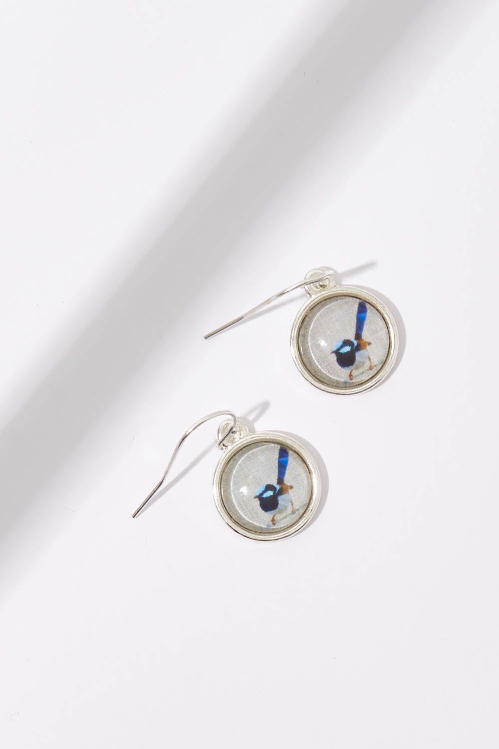 A model wearing the Blue Wren Drop Earrings in colour Grey (Grey), from the front, showing the whole outfit