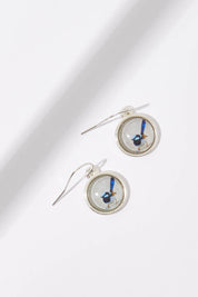 A model wearing the Blue Wren Drop Earrings in colour Grey (Grey), from the front, showing the whole outfit