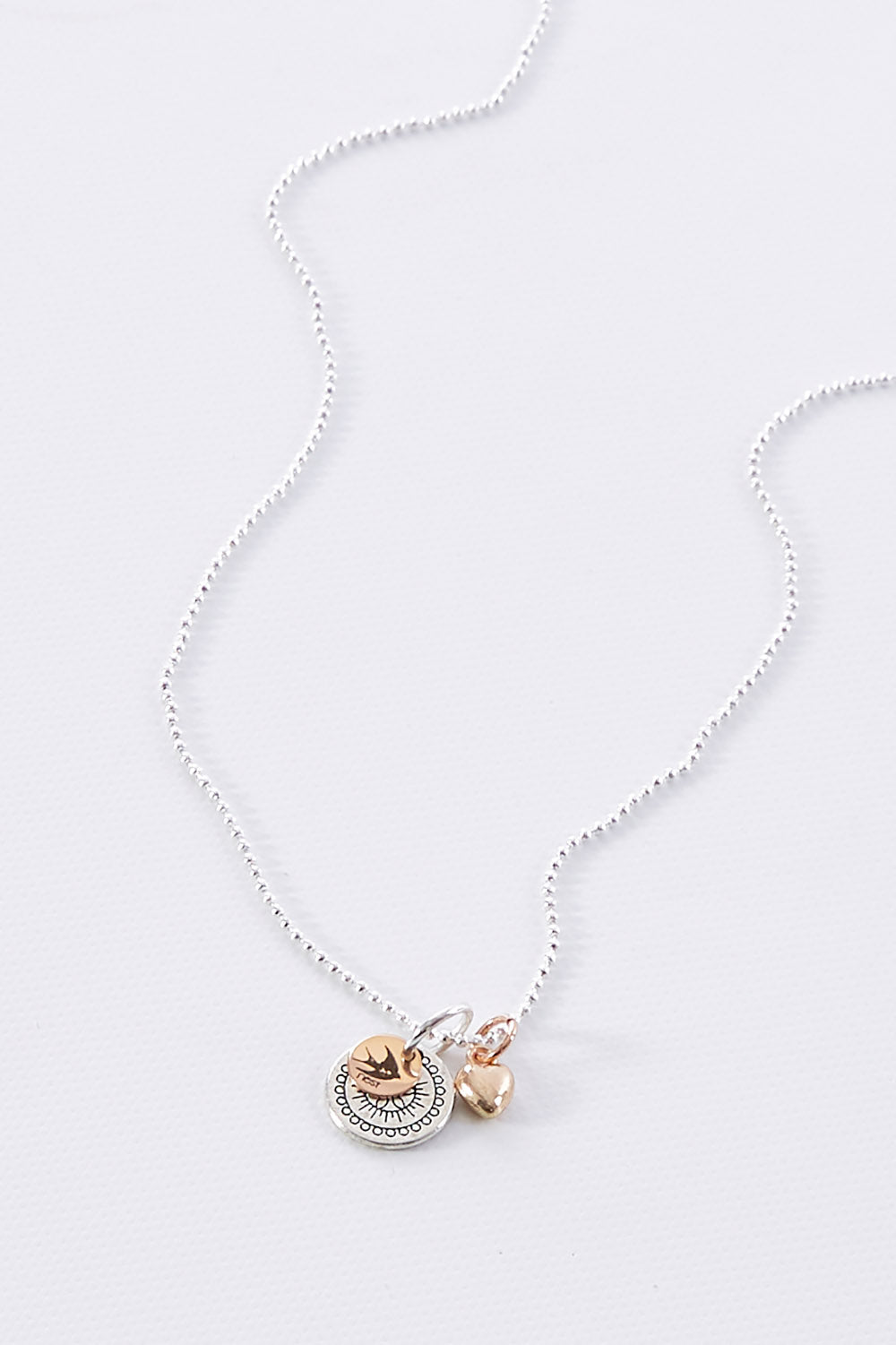 A model wearing size OneSize of the Circle Of The Sun Pendant Necklace in colour Silver (Metallics), from the front, showing the whole outfit