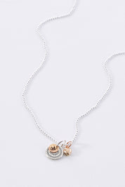 A model wearing size OneSize of the Circle Of The Sun Pendant Necklace in colour Silver (Metallics), from the front, showing the whole outfit