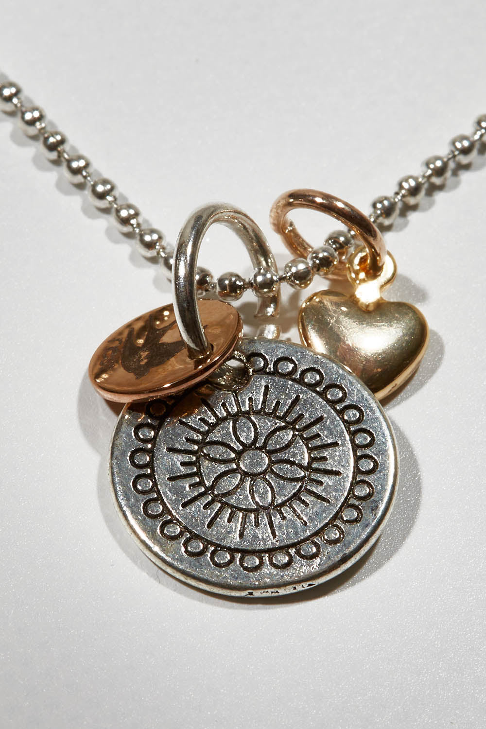 A model wearing size OneSize of the Circle Of The Sun Pendant Necklace in colour Silver (Metallics), from the front, showing the whole outfit