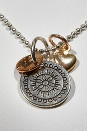 A model wearing size OneSize of the Circle Of The Sun Pendant Necklace in colour Silver (Metallics), from the front, showing the whole outfit
