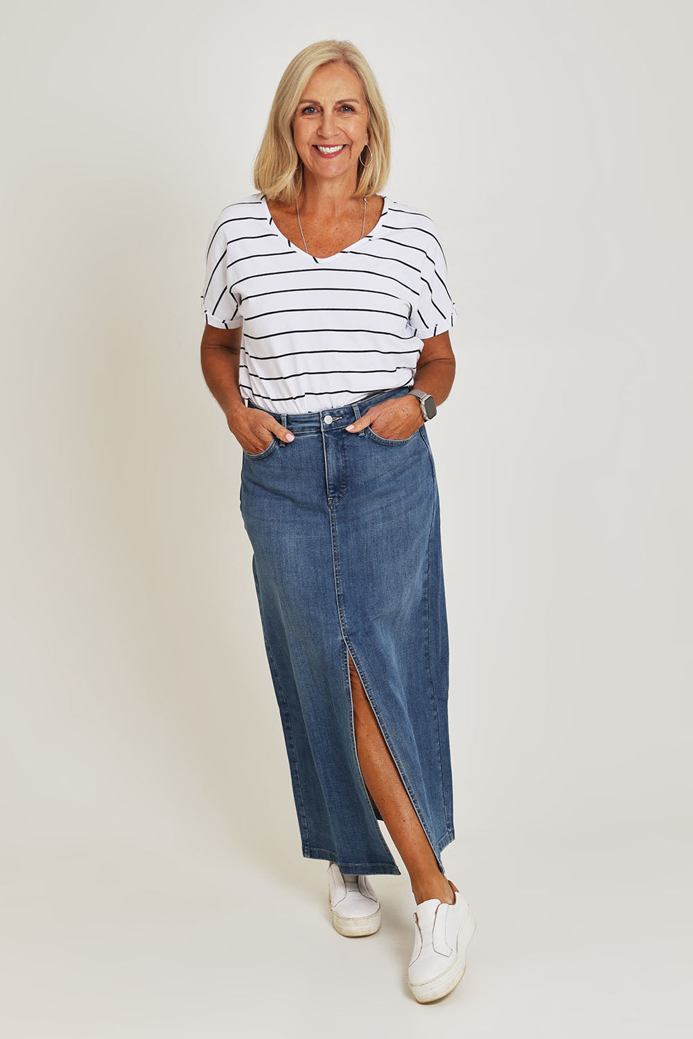 Model Sandy wearing the High Rise Long Skirt in colour Fairmont (Blue), from the front, showing the whole outfit
