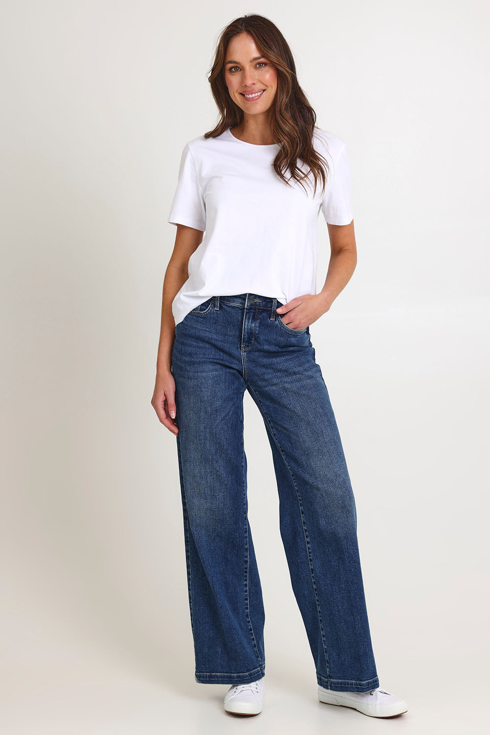 Model Madeline wearing the Teresa Wide Leg Jeans in colour Riorapids (Blue), from the front, showing the whole outfit