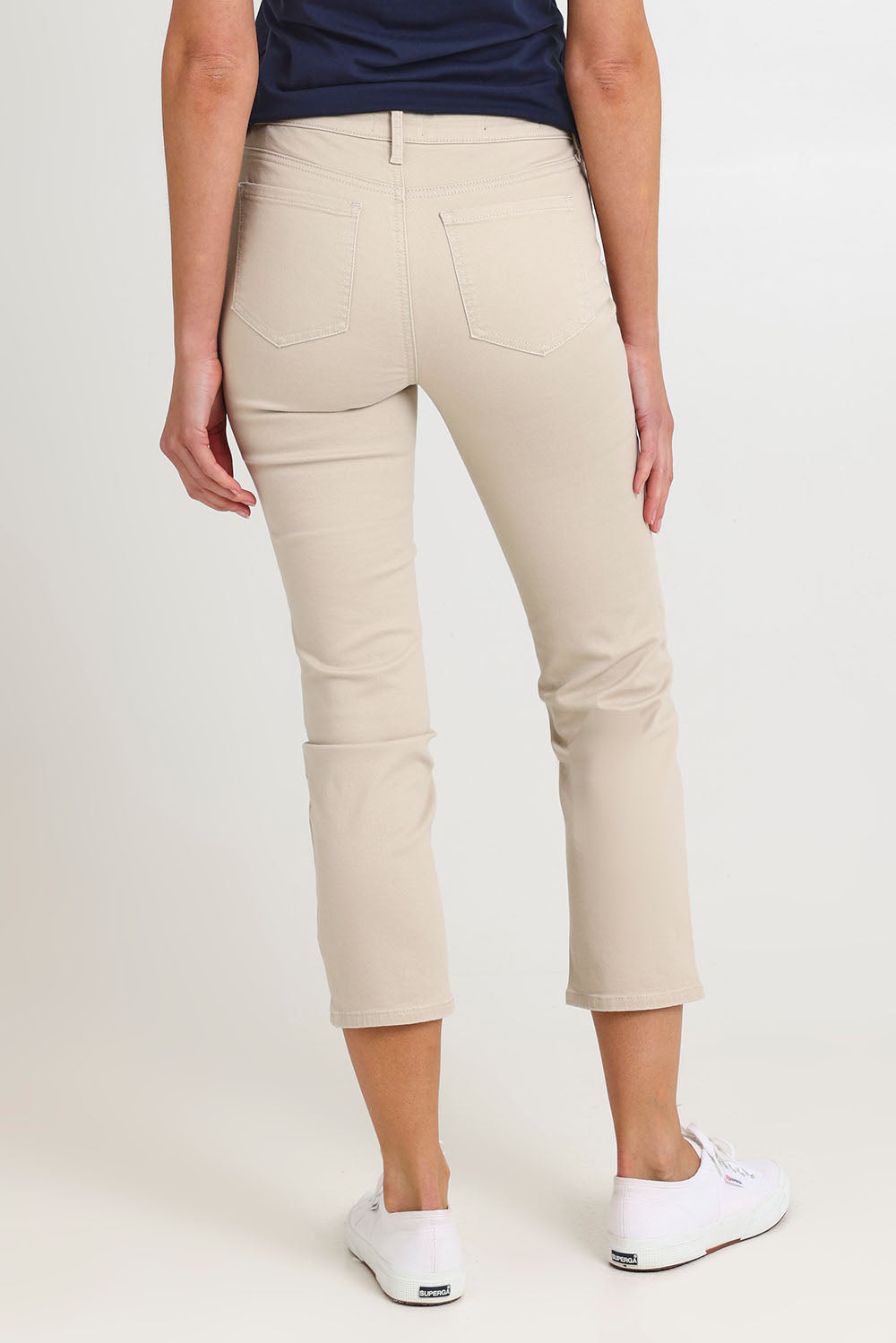 Model Madeline wearing the Sheri Slim Ankle Jean in colour Feather, from the back