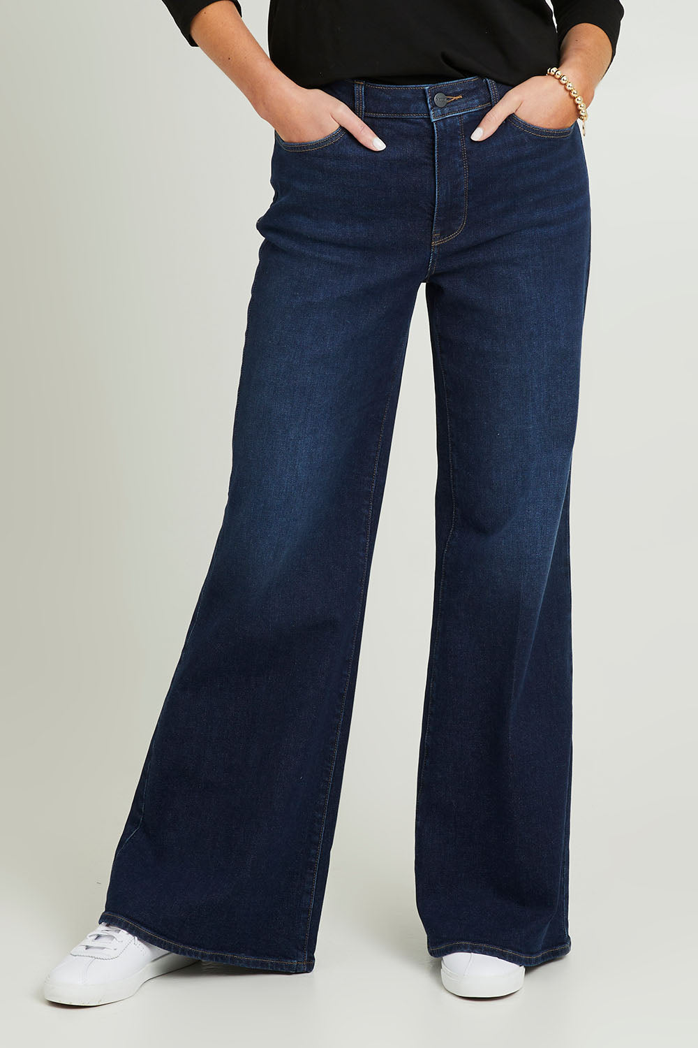 Model Grace wearing the Mia Palazzo Pant in colour Northbridg (Blue), from the front, cropped image
