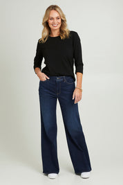 Model Grace wearing the Mia Palazzo Pant in colour Northbridg (Blue), from the front, showing the whole outfit