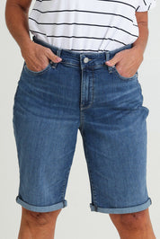 Model Sandy wearing the Briella Short in colour Valencia (Blue), from the front, cropped image