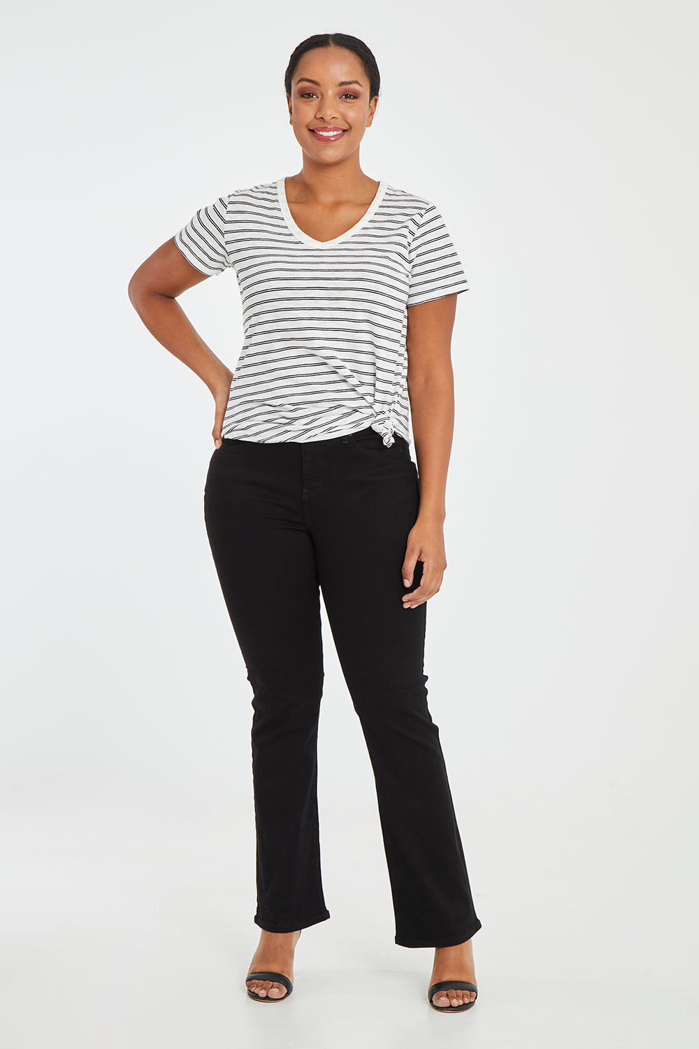 Model Noli wearing the Barbara Bootcut Jean in colour Black (Black), from the front, showing the whole outfit