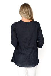 A model wearing the Evie 3/4 Sleeve Pleated Cotton Top in colour Navy (Blue), from the back