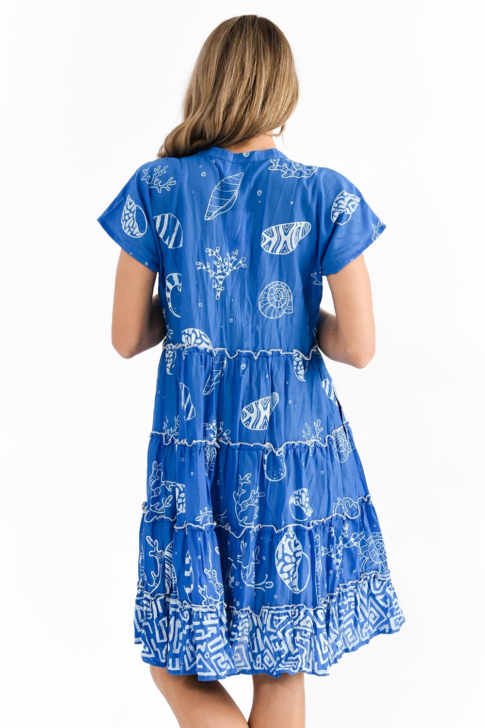 A model wearing the Tiered Cotton Dress in colour Cobalt (Blue), from the back