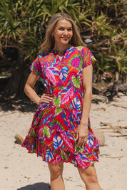 Model Genericm wearing size sample of the Leela Cotton Dress - Coral in colour Coral, in a cropped view