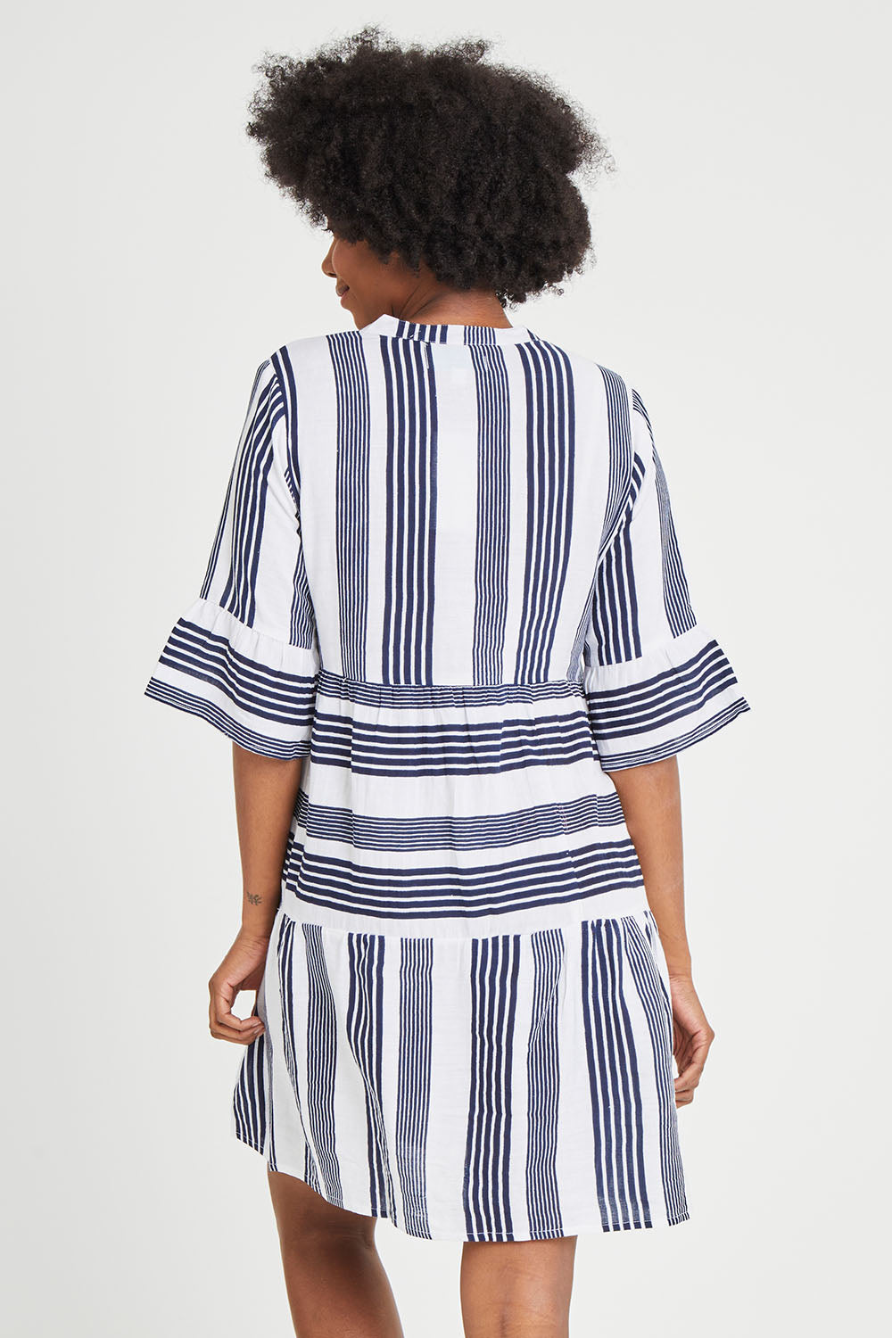 Model Aiyana wearing size 10 of the Maya Button V Neck Layer Dress in colour Navy (Blue), from the back