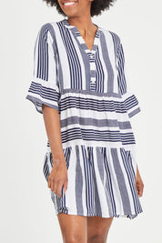 Model Aiyana wearing size 10 of the Maya Button V Neck Layer Dress in colour Navy (Blue), from the front, cropped image