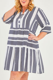 Model Caitlin wearing size 18 of the Maya Button V Neck Layer Dress in colour Navy (Blue), from the front, cropped image