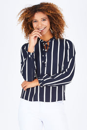 Model Summer wearing size S of the Nova Lux Long Sleeve Tie Top in colour AidaStripe (Black), from the front, cropped image