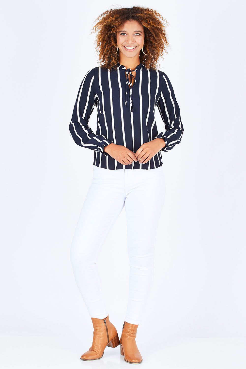 Model Summer wearing size S of the Nova Lux Long Sleeve Tie Top in colour AidaStripe (Black), from the front, showing the whole outfit