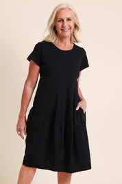 Model Sandys wearing size 10 of the Essentials Bubble Cotton Knit Dress - Black in colour Black, in a cropped view