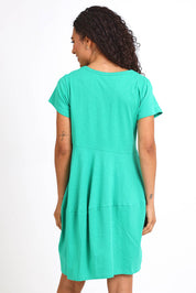 Model Pamelar wearing size 10 of the Essentials Bubble Cotton Knit Dress - Green in colour Green, from an angle