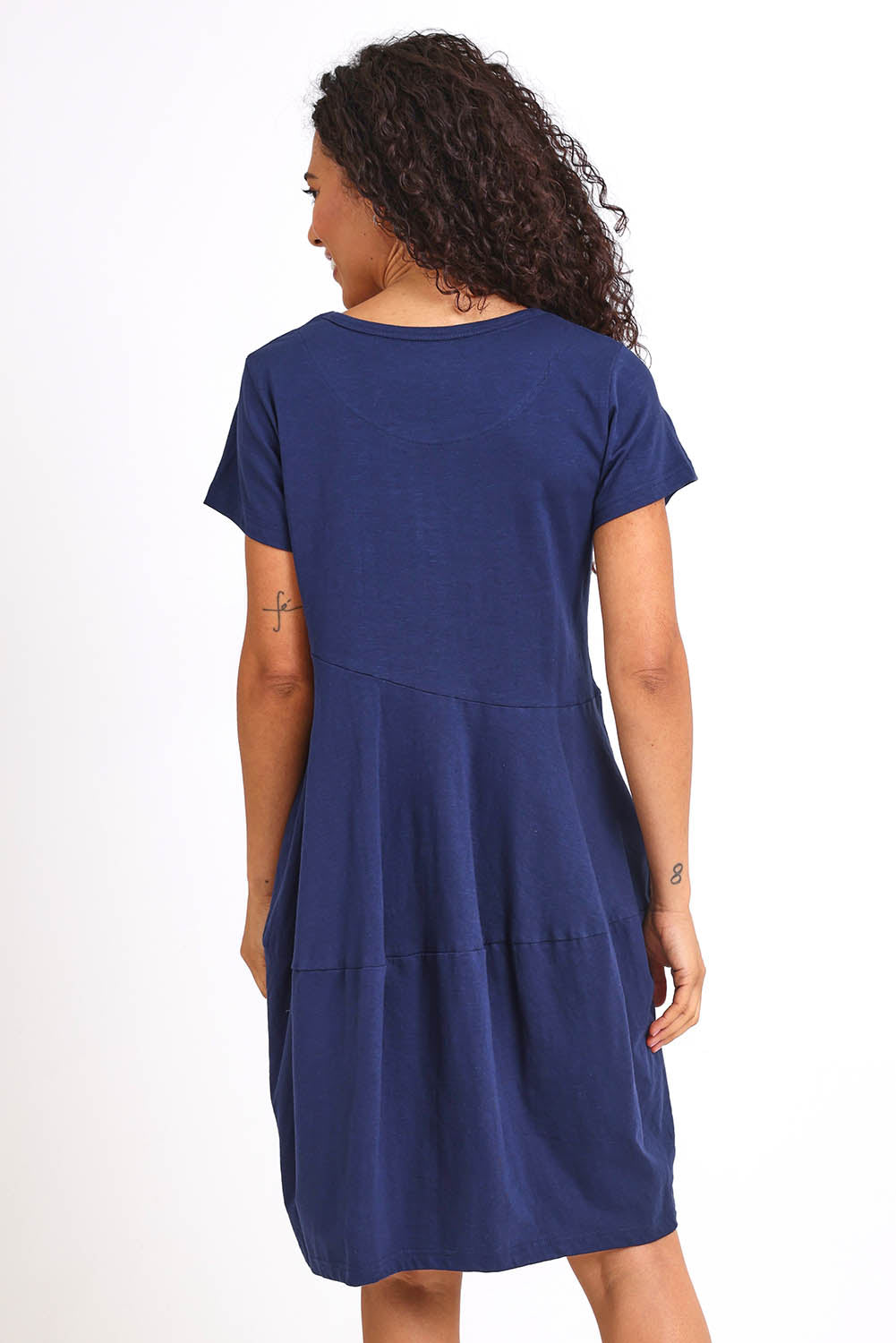 Model Pamelar wearing size 10 of the Essentials Bubble Cotton Knit Dress - Navy in colour Navy, from the back