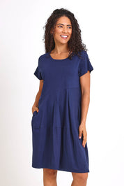 Model Pamelar wearing size 10 of the Essentials Bubble Cotton Knit Dress - Navy in colour Navy, from the front