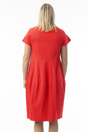 A model wearing the Essentials Organic Cotton Bubble Dress in colour Red (Red), from the back