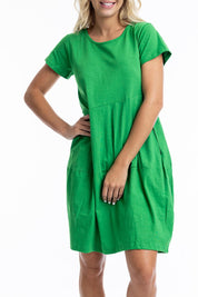A model wearing the Essentials Knit Bubble Dress in colour Parakeet (Green), from the front, cropped image