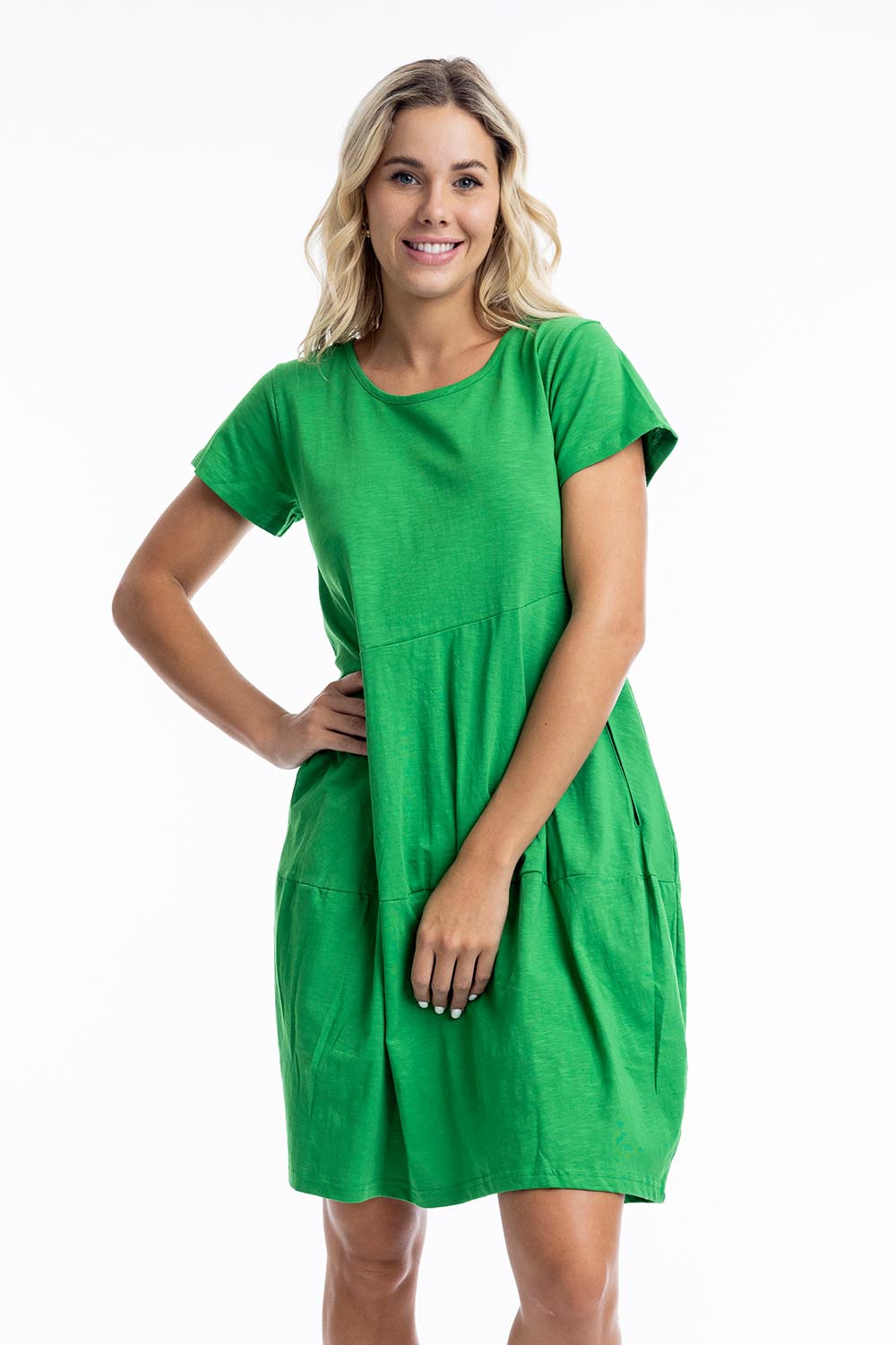 A model wearing the Essentials Knit Bubble Dress in colour Parakeet (Green), from the front, cropped image