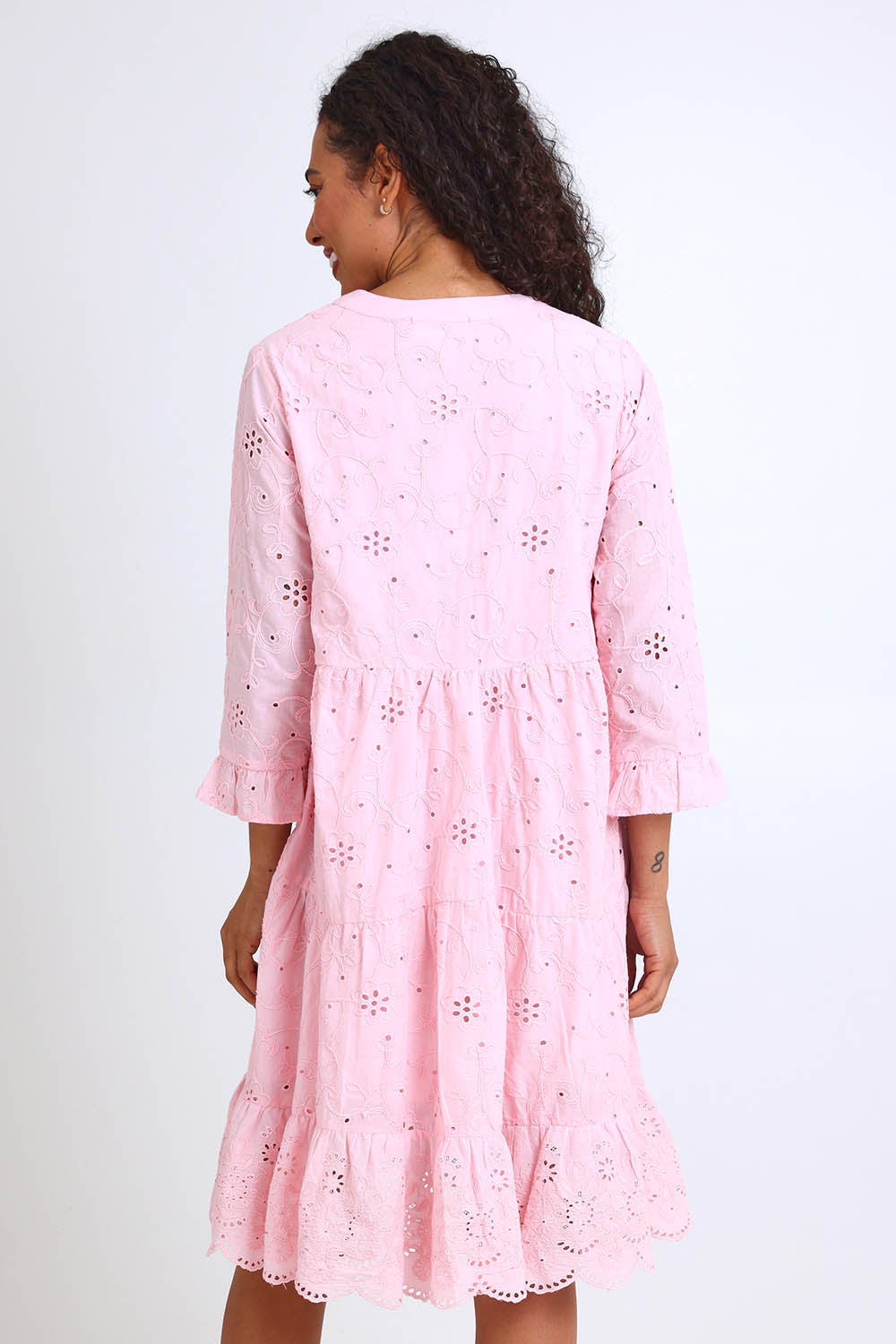 Model Pamelar wearing size 10 of the Essentials Broderie Frill Hem and Sleeves Dress - Pink in colour Pink, from the back