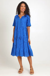 Model Pamelar wearing size 10 of the Essentials Broderie Layers Dress - Blue in colour Blue, from the front