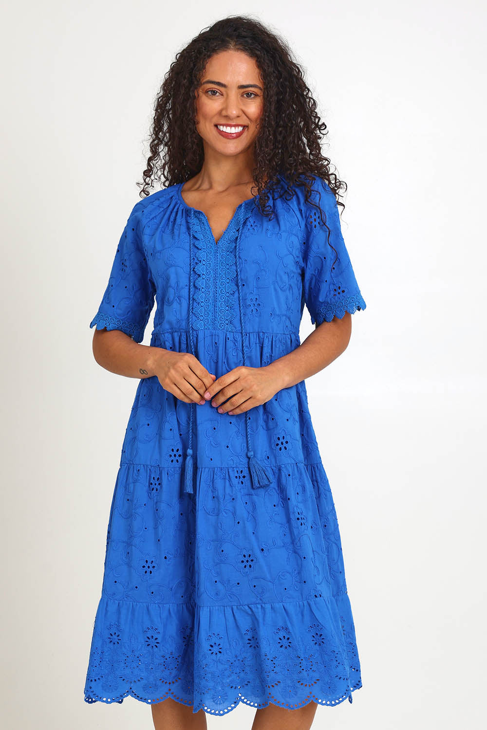 Model Pamelar wearing size 10 of the Essentials Broderie Layers Dress - Blue in colour Blue, from the front