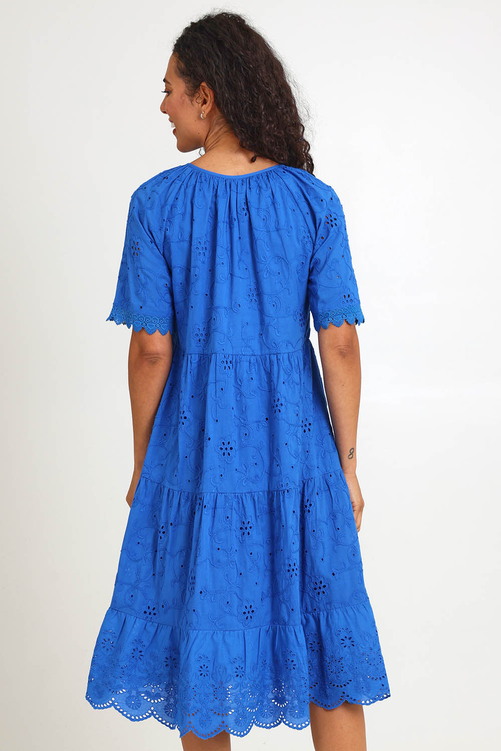 Model Pamelar wearing size 10 of the Essentials Broderie Layers Dress - Blue in colour Blue, from the front