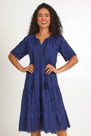 Model Pamelar wearing size 10 of the Essentials Broderie Layers Dress - Navy in colour Navy, in a cropped view