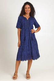 Model Pamelar wearing size 10 of the Essentials Broderie Layers Dress - Navy in colour Navy, from the front