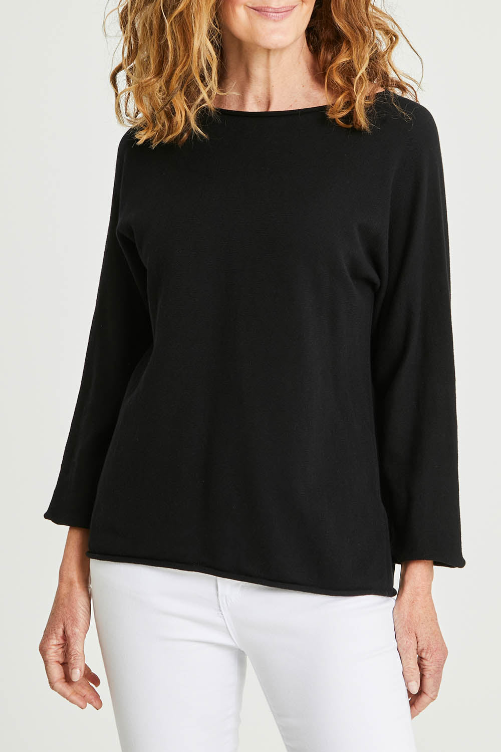 Model Emma wearing size 10 of the Knit Organic Cotton Top Long Sleeve in colour Black (Black), from the front, cropped image