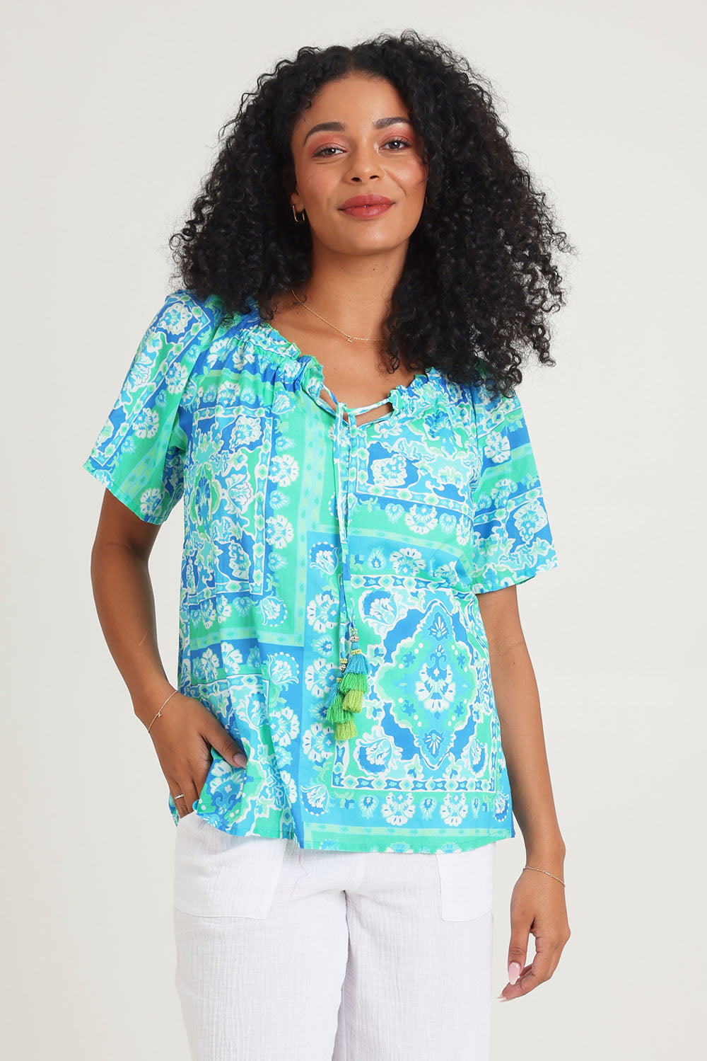 Model Ziara wearing size 10 of the Short Sleeve Cotton Top in colour Aqua (Blue), from the front, cropped image