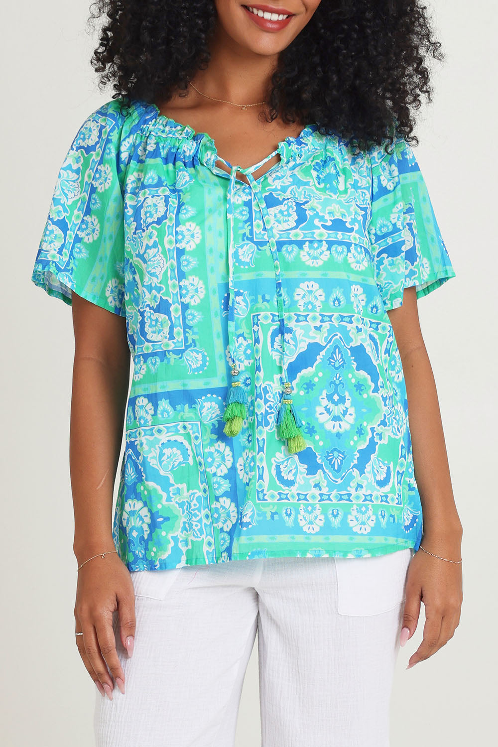 Model Ziara wearing size 10 of the Short Sleeve Cotton Top in colour Aqua (Blue), from the front, cropped image