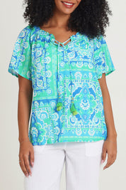 Model Ziara wearing size 10 of the Short Sleeve Cotton Top in colour Aqua (Blue), from the front, cropped image