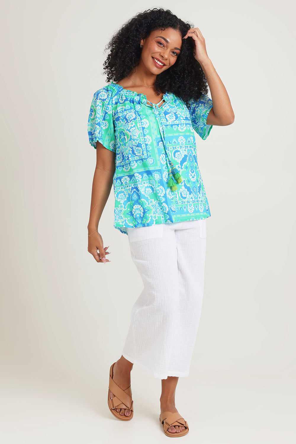Model Ziara wearing size 10 of the Short Sleeve Cotton Top in colour Aqua (Blue), from the front, showing the whole outfit