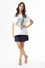 A model wearing the Embellished Cotton Tee in colour Whitepalm (White), from the front, showing the whole outfit