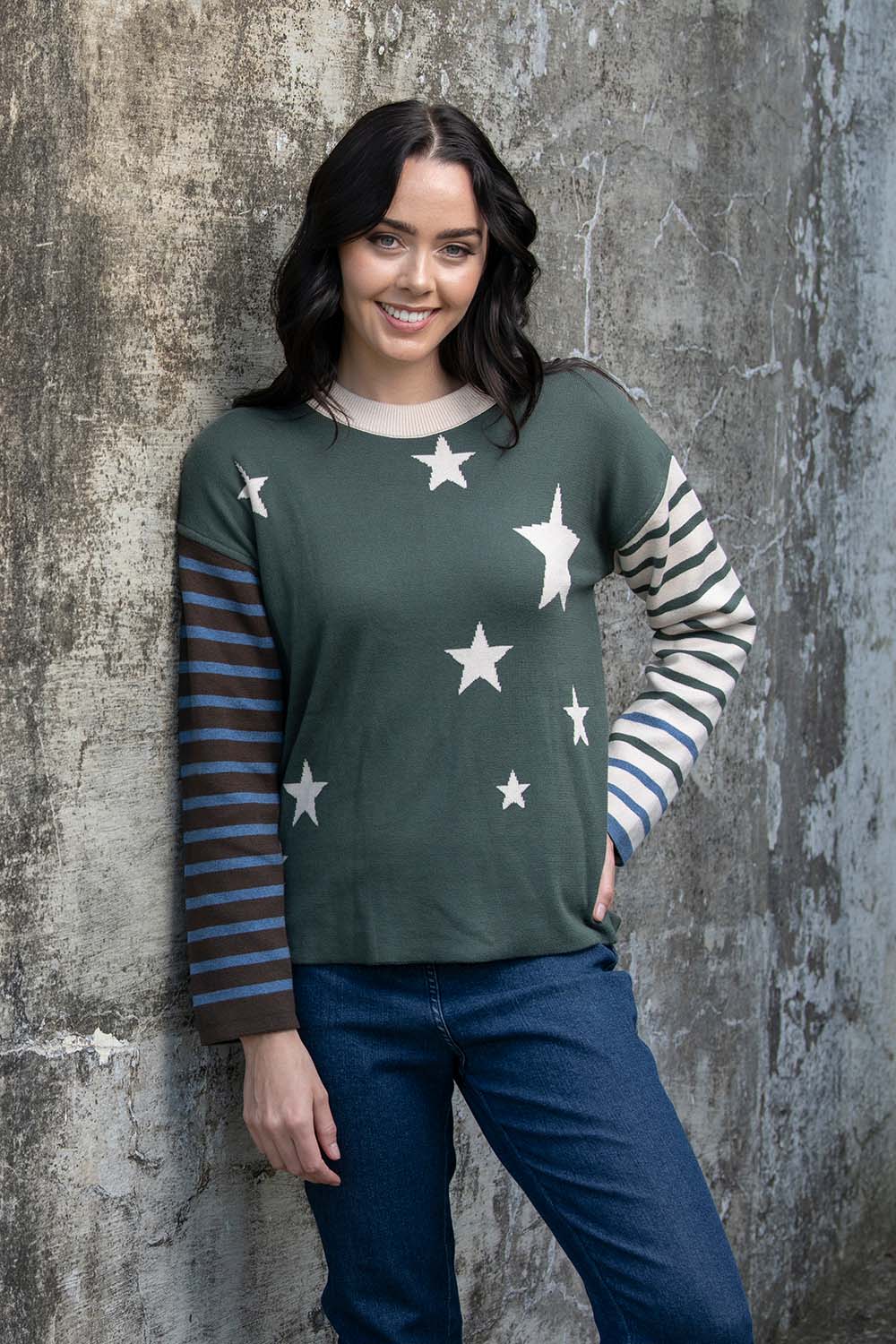 A model wearing the Knit Reversible Organic Cotton Jumper in colour Colour1 (Green), from the front, showing the whole outfit