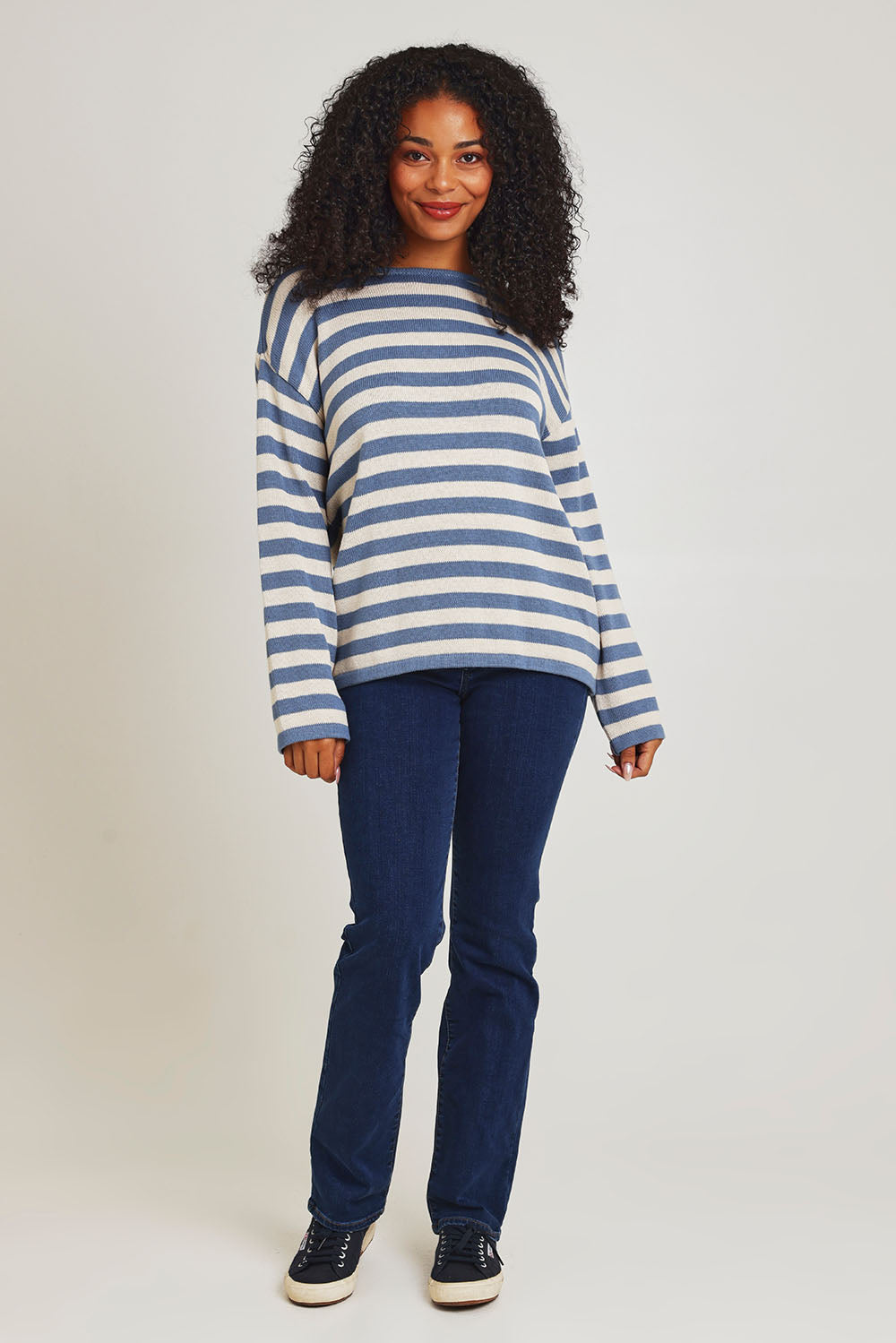 Model Ziara wearing size 10 of the Essentials Organic Cotton Knit Stripe Top in colour Denim (Blue), from the front, showing the whole outfit