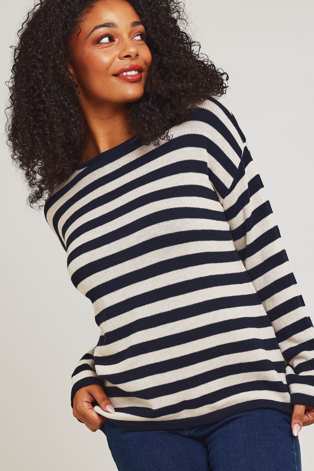 Model Ziara wearing size 10 of the Essentials Organic Cotton Knit Stripe Top in colour Navynatur (Blue), from the front, cropped image