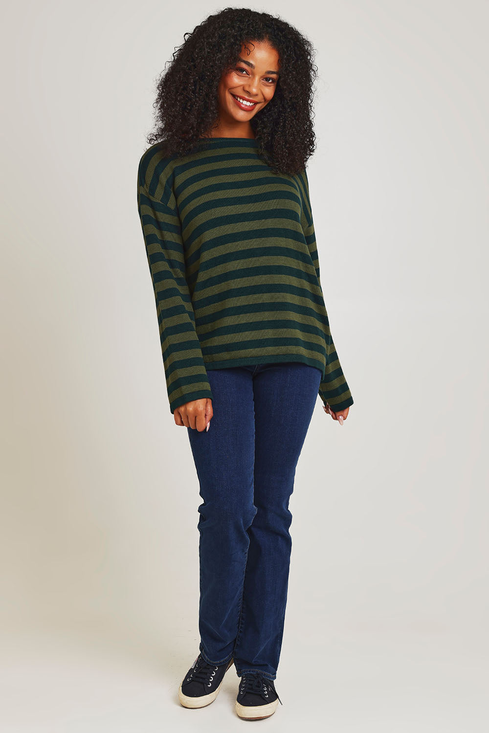 Model Ziara wearing size 10 of the Essentials Organic Cotton Knit Stripe Top in colour Pineolive (Green), from the front, showing the whole outfit