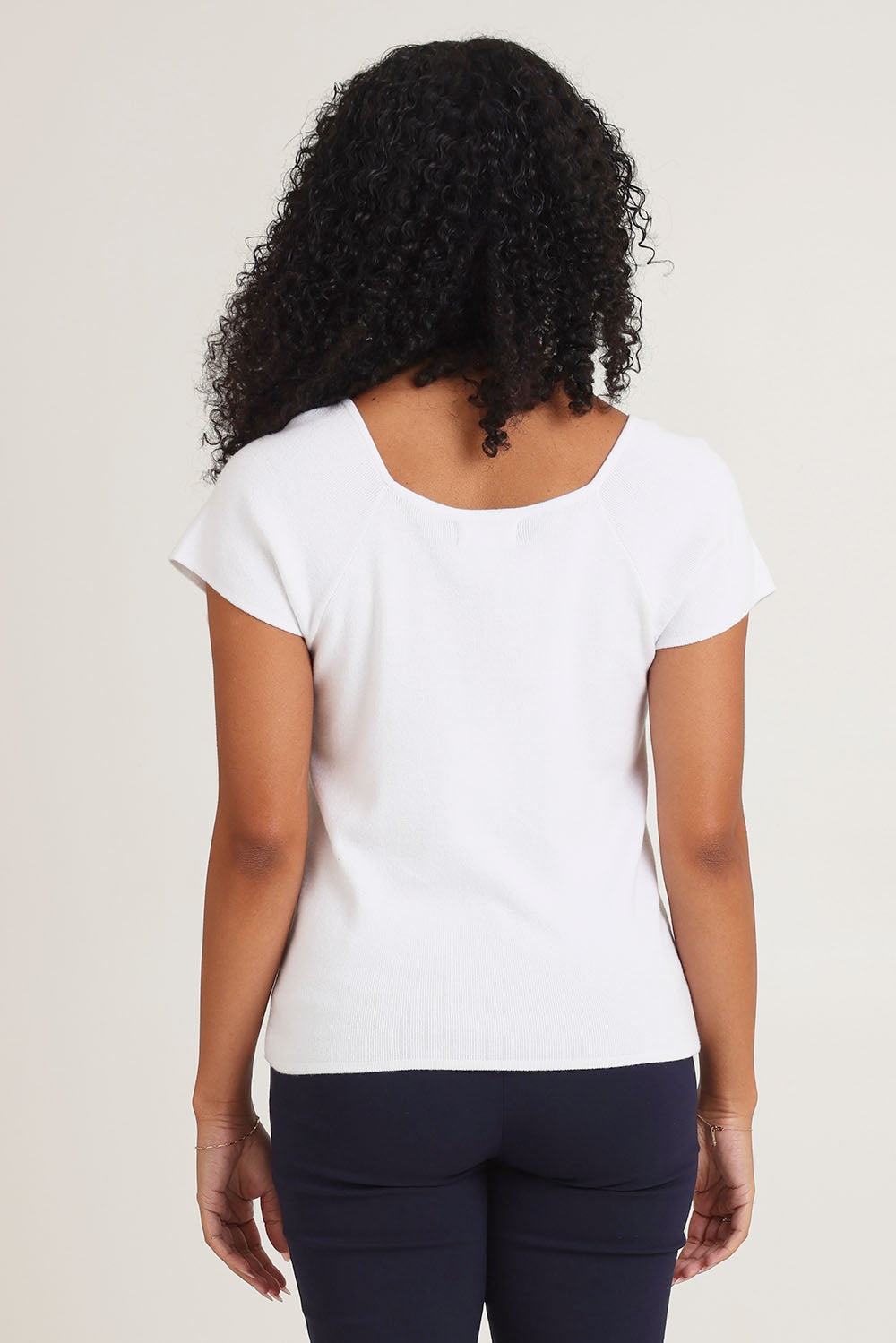 Model Ziara wearing size 10 of the Essentials Squareneck Knit Cotton Top in colour White (White), from the back