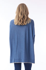 A model wearing the Knit Oversize Top in colour Denim (Blue), from the back