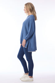 A model wearing the Knit Oversize Top in colour Denim (Blue), from the front, showing the whole outfit